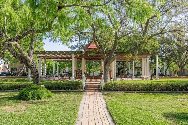 view of property's community with a lawn and a pergola