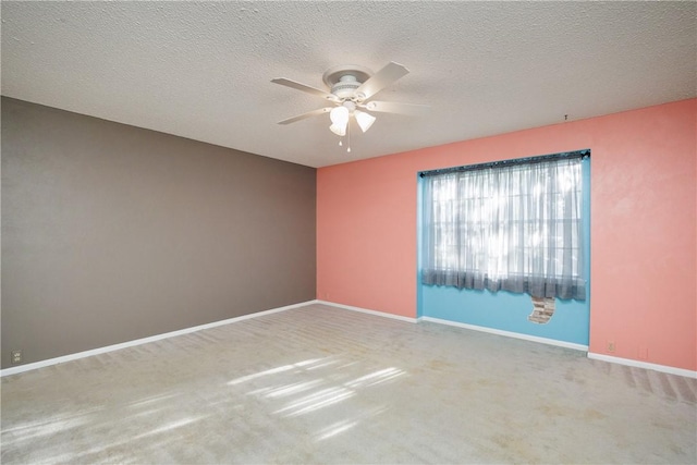 spare room with carpet flooring, a textured ceiling, and ceiling fan