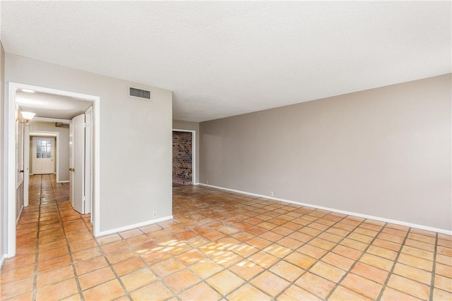 41 Townhouse, Corpus Christi, TX 78412 - unfurnished room with baseboards, light tile patterned floors, and a textured ceiling
