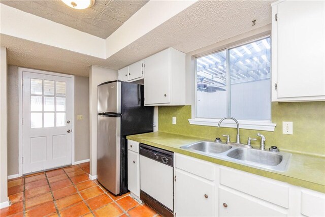 41 Townhouse, Corpus Christi, TX 78412 - kitchen featuring dishwasher, a sink, white cabinets, light countertops, and plenty of natural light