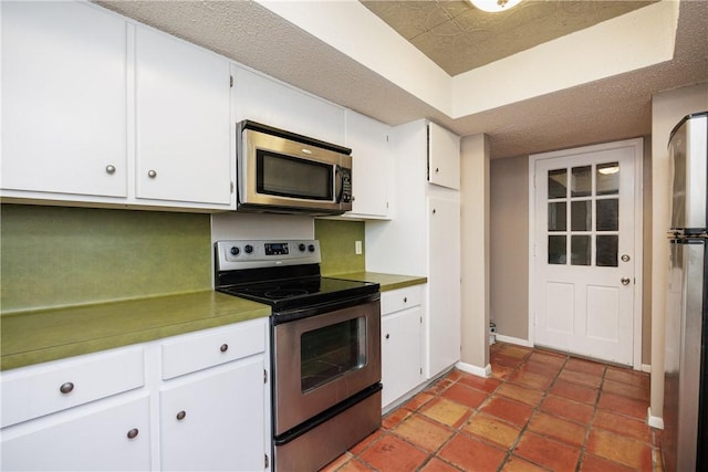 kitchen featuring white cabinetry, light tile patterned floors, and stainless steel appliances