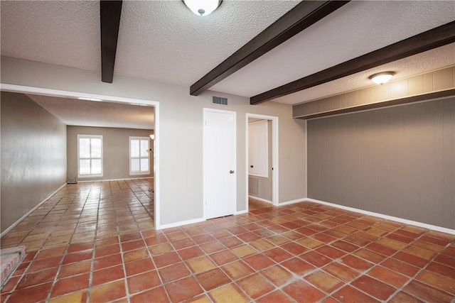 basement with tile patterned floors, a textured ceiling, and wooden walls