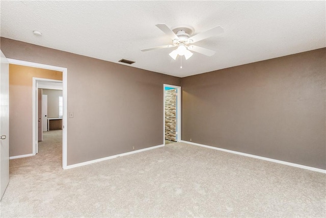 41 Townhouse, Corpus Christi, TX 78412 - unfurnished room featuring ceiling fan, light carpet, baseboards, and a textured ceiling