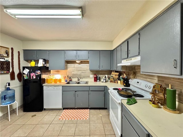 kitchen with sink, white appliances, gray cabinets, decorative backsplash, and light tile patterned flooring