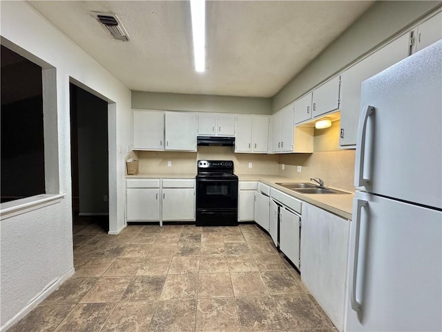 kitchen with electric range, white fridge, white cabinets, and sink