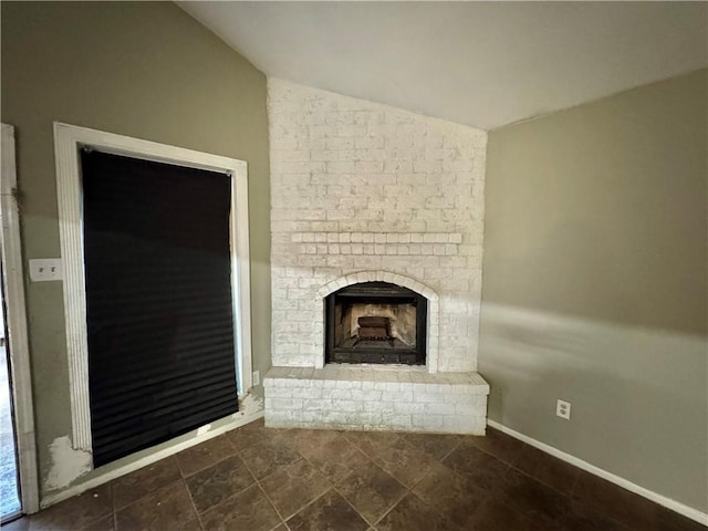 unfurnished living room with a fireplace and vaulted ceiling