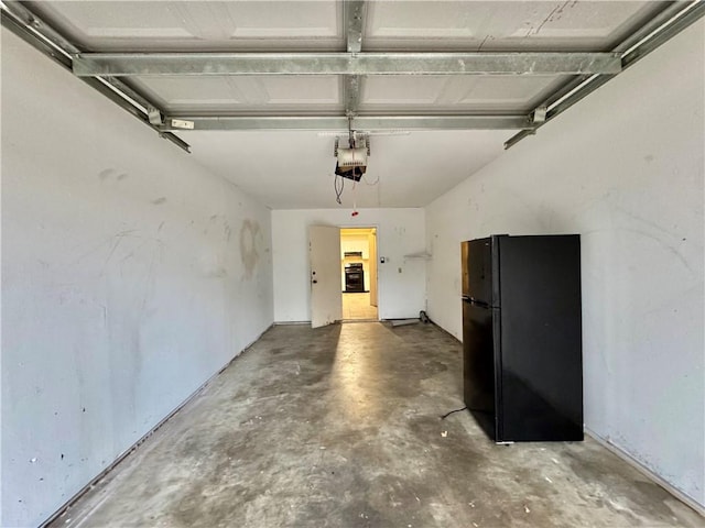 garage with black fridge and a garage door opener