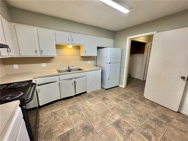 kitchen featuring white cabinets, white refrigerator, sink, and black / electric stove