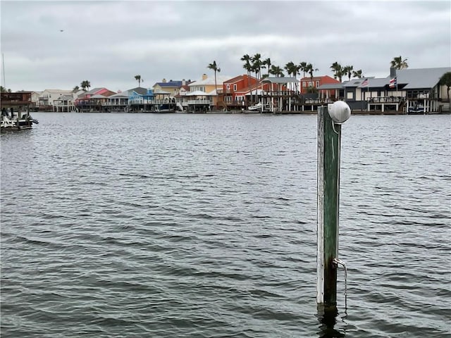 dock with a residential view and a water view
