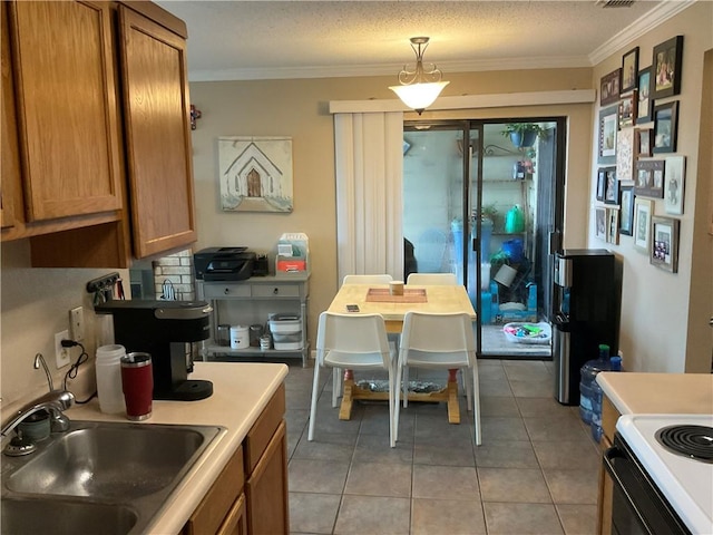 kitchen with brown cabinetry, a sink, ornamental molding, electric range, and light tile patterned floors