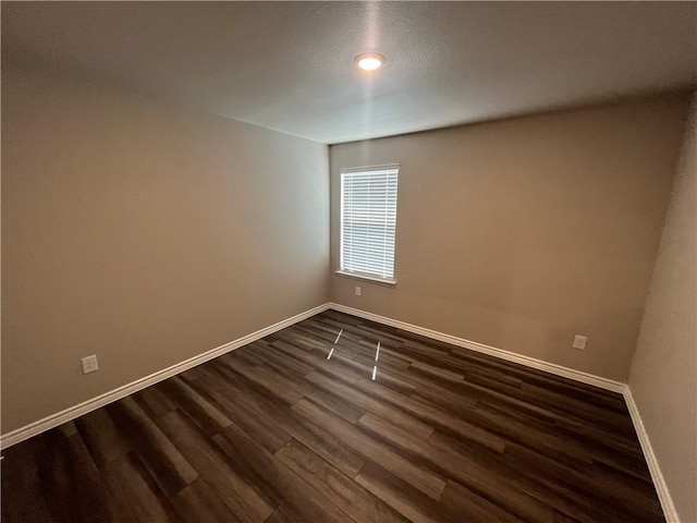 7201 Wilder Ln, Corpus Christi, TX 78414 - spare room featuring baseboards and dark wood-style floors