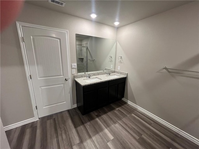 7201 Wilder Ln, Corpus Christi, TX 78414 - bathroom with double vanity, a stall shower, wood finished floors, and recessed lighting