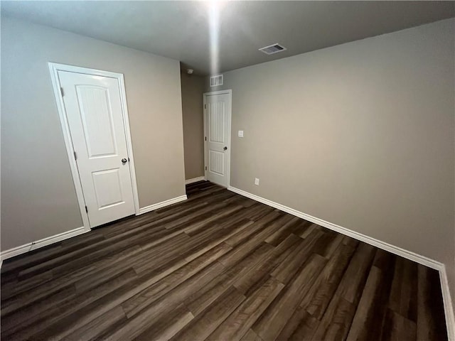 7201 Wilder Ln, Corpus Christi, TX 78414 - unfurnished bedroom with dark wood-style flooring and baseboards