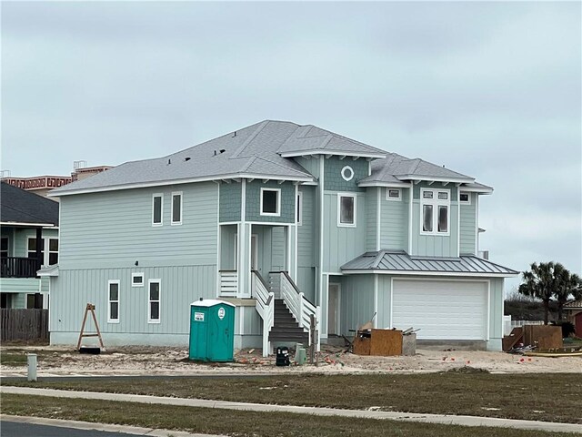 rear view of property featuring a garage