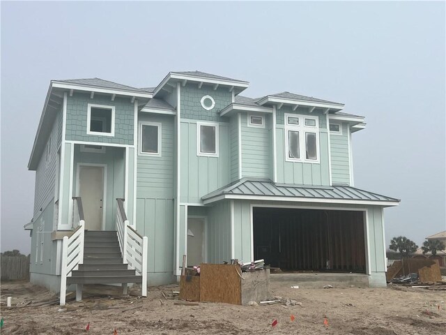 back of property with a balcony and covered porch