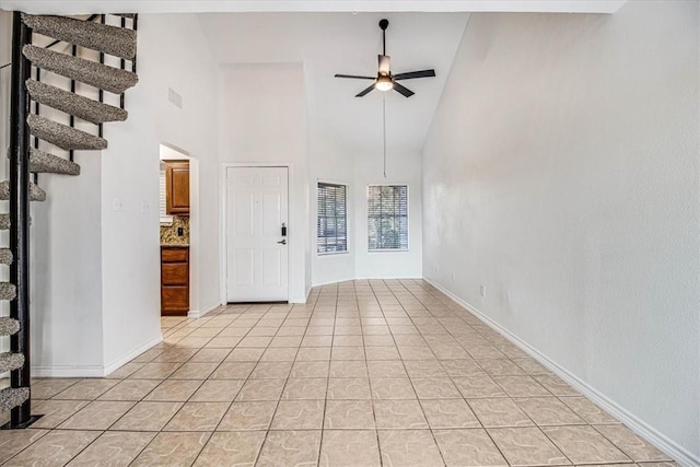 interior space with high vaulted ceiling and ceiling fan