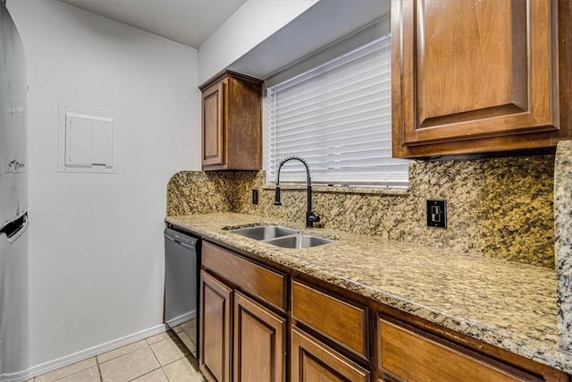 kitchen with light tile patterned flooring, dishwasher, sink, backsplash, and light stone countertops