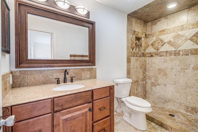 bathroom with vanity, toilet, and a shower