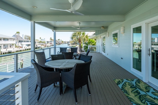 31 Bahama Dr, Rockport, TX 78382 - deck featuring ceiling fan, outdoor dining space, and a water view