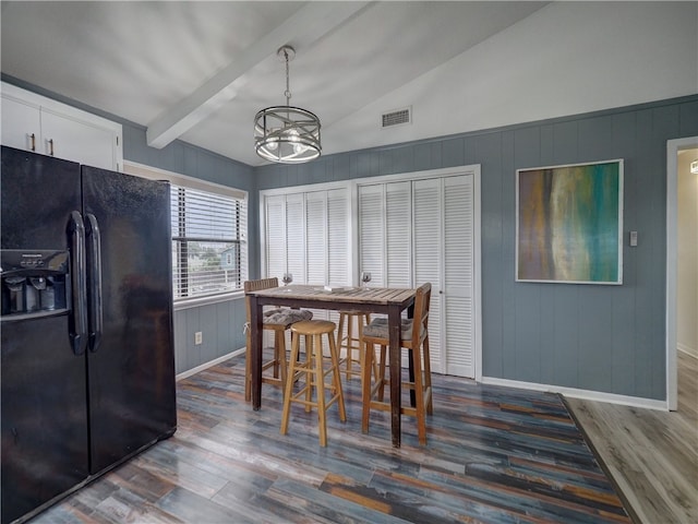 dining area with vaulted ceiling with beams, dark hardwood / wood-style floors, and a chandelier