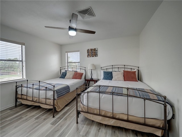 bedroom with ceiling fan and light hardwood / wood-style flooring