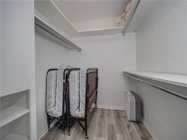 walk in closet with light wood-type flooring