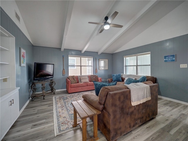 living room featuring lofted ceiling with beams, ceiling fan, and light hardwood / wood-style flooring