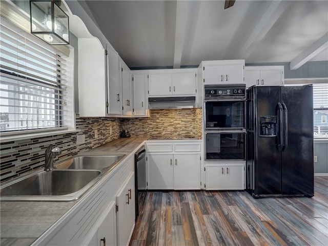 kitchen with dark wood-type flooring, black appliances, sink, beamed ceiling, and white cabinetry