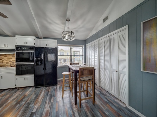 kitchen with black appliances, lofted ceiling with beams, dark hardwood / wood-style floors, pendant lighting, and white cabinets