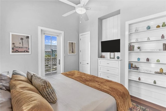 bedroom with access to outside, a ceiling fan, and wood finished floors