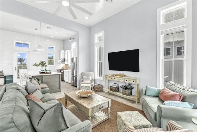 living room with ceiling fan and recessed lighting