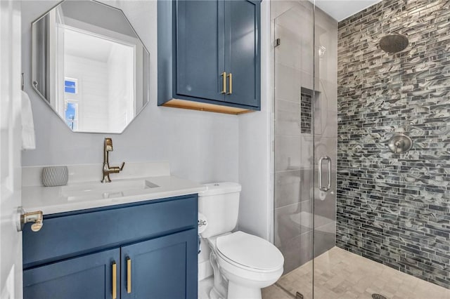 full bath featuring toilet, a shower stall, and vanity