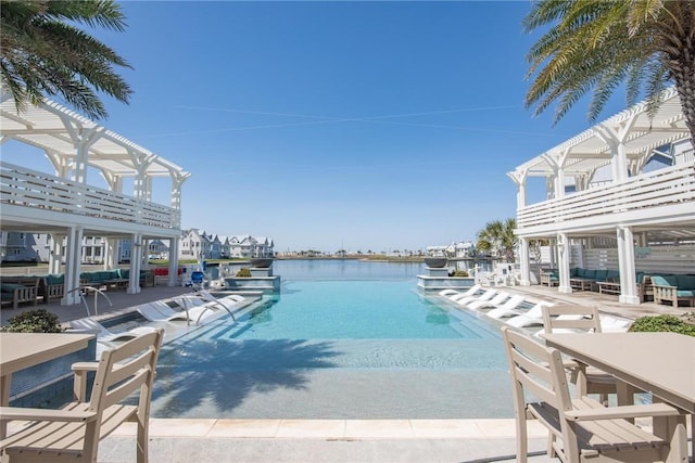 community pool with a patio and a water view