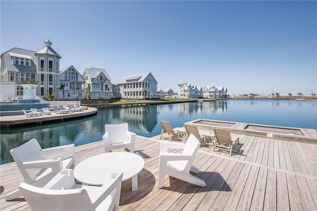 dock area with a residential view and a water view