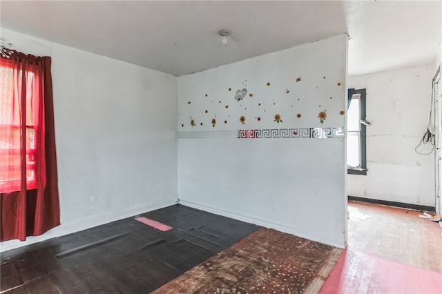 spare room with wood-type flooring