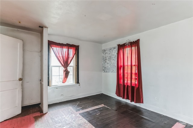 empty room featuring dark wood-type flooring