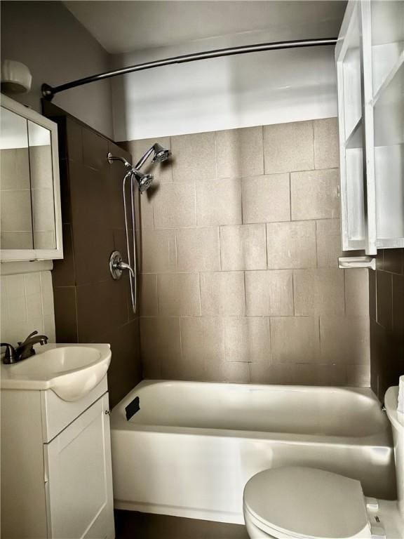 full bathroom featuring vanity, toilet, and tiled shower / bath combo