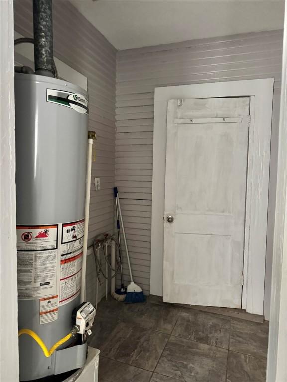 utility room featuring water heater