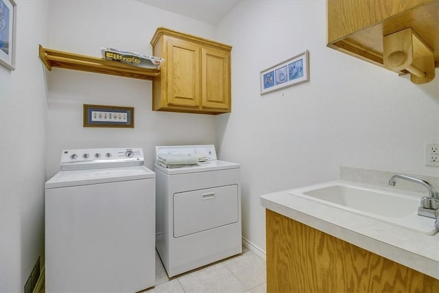 637 Pompano Dr, Aransas Pass, TX 78336 - washroom featuring cabinet space, washing machine and clothes dryer, and light tile patterned flooring