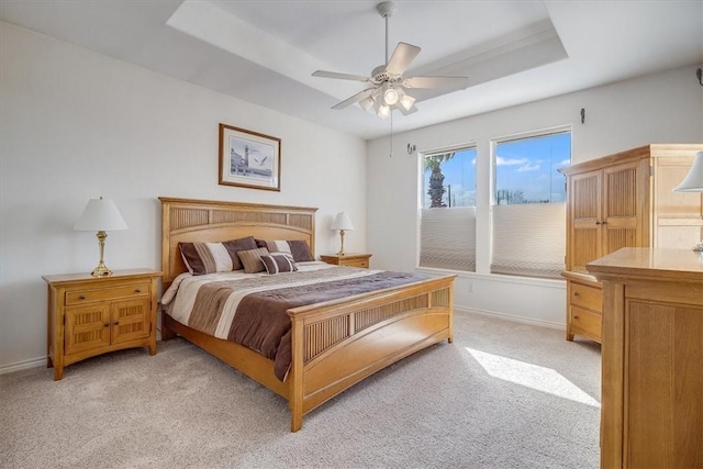 637 Pompano Dr, Aransas Pass, TX 78336 - bedroom featuring light colored carpet, a raised ceiling, and a ceiling fan