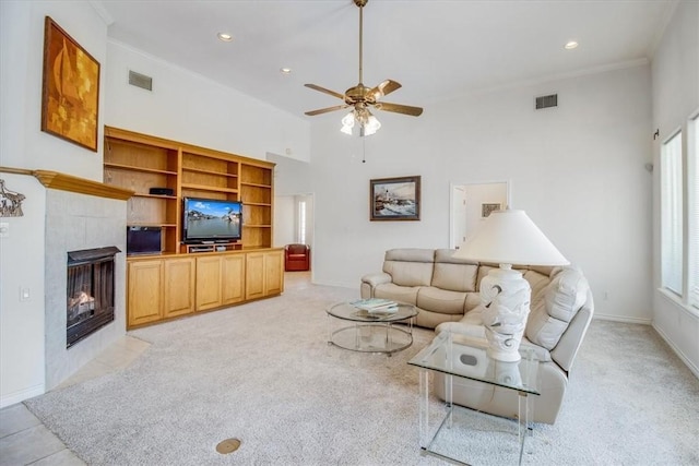 637 Pompano Dr, Aransas Pass, TX 78336 - living area featuring ceiling fan, light carpet, a tile fireplace, recessed lighting, and crown molding