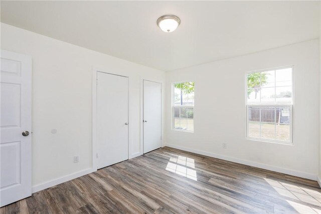 1336 Brentwood Dr, Corpus Christi, TX 78415 - unfurnished bedroom featuring wood finished floors and baseboards