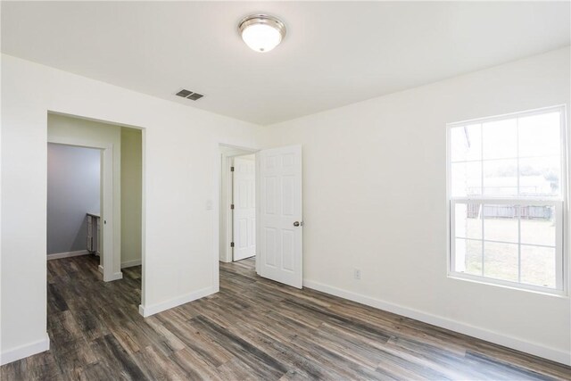 1336 Brentwood Dr, Corpus Christi, TX 78415 - unfurnished bedroom featuring wood finished floors and baseboards