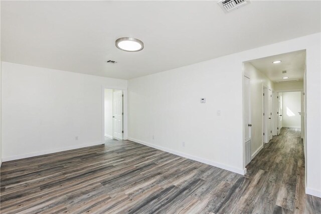 1336 Brentwood Dr, Corpus Christi, TX 78415 - spare room featuring dark wood-type flooring, baseboards, and recessed lighting