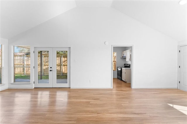 unfurnished living room featuring light wood-style flooring, french doors, baseboards, and high vaulted ceiling