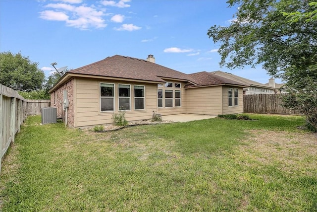 7206 Spanish Wood Dr, Corpus Christi, TX 78414 - rear view of property featuring a chimney, central AC unit, a fenced backyard, a patio area, and a lawn