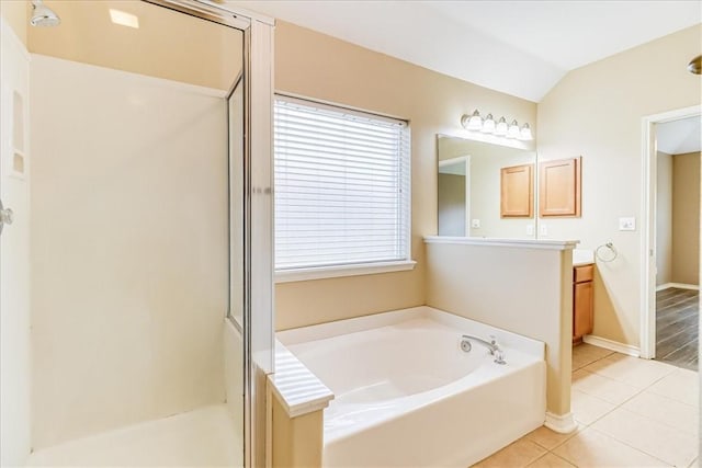 7206 Spanish Wood Dr, Corpus Christi, TX 78414 - bathroom with a bath, tile patterned floors, lofted ceiling, a shower stall, and vanity