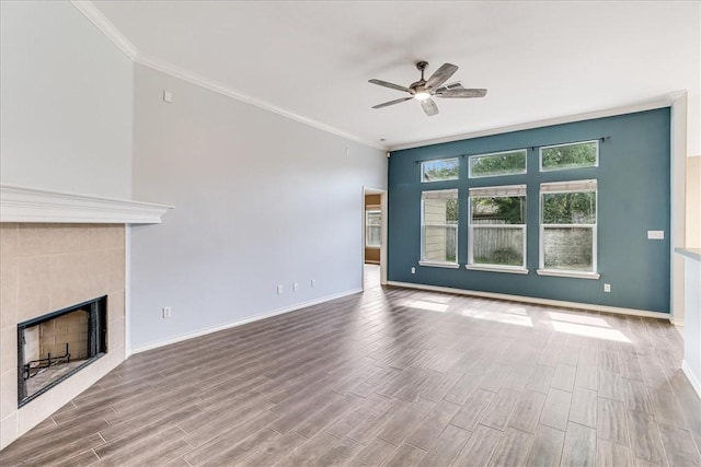 7206 Spanish Wood Dr, Corpus Christi, TX 78414 - unfurnished living room with a tile fireplace, ceiling fan, crown molding, and wood finished floors
