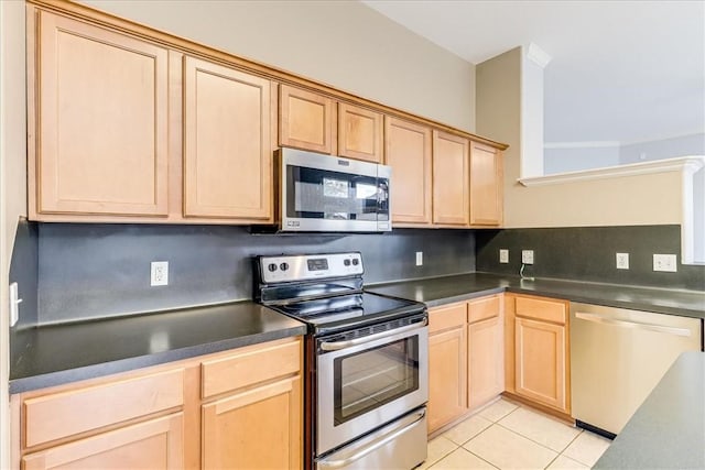 7206 Spanish Wood Dr, Corpus Christi, TX 78414 - kitchen featuring dark countertops, light brown cabinetry, appliances with stainless steel finishes, and light tile patterned floors