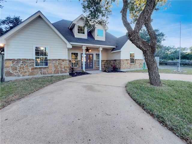 view of front of home with covered porch and a front yard